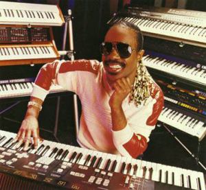 Stevie Wonder smiling in front of the keyboard