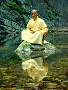Meditation man sitting on a rock